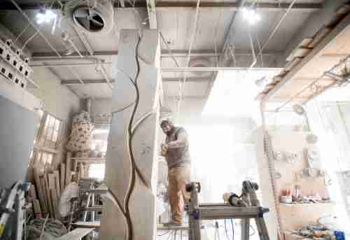 Artist Jason Quigno works on stone sculpture in his studio